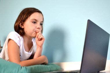 Girl student online learning class study online video call zoom teacher, Happy girl learn english language online with laptop at home. New normal. Social distancing. stay home . High quality photo