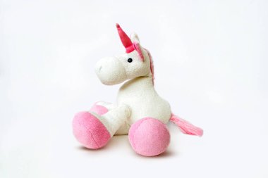 Lovely white pony doll isolated on white background. Adorable teddy bear for decorative. High quality photo