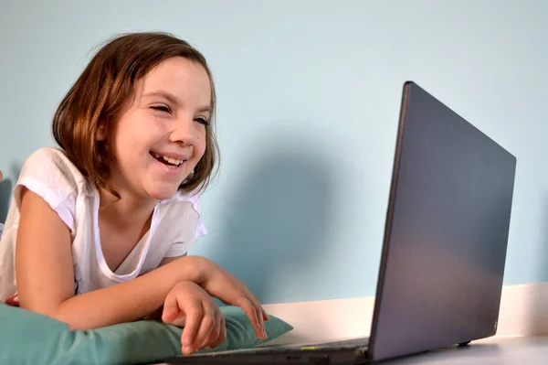 Girl student online learning class study online video call zoom teacher, Happy girl learn english language online with laptop at home. New normal. Social distancing. stay home . High quality photo