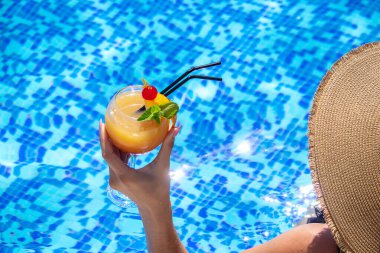 Kız havuzda kokteyl içiyor. Doğa. seçici odak