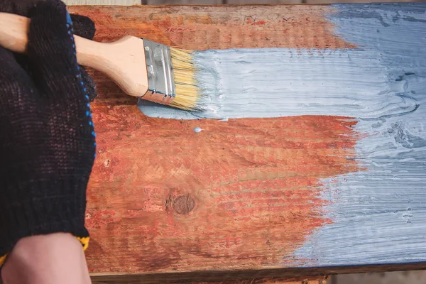 Elleriniz fırçayı tutsun, tahtaya cila sürün. tahta boyası. seçici odak