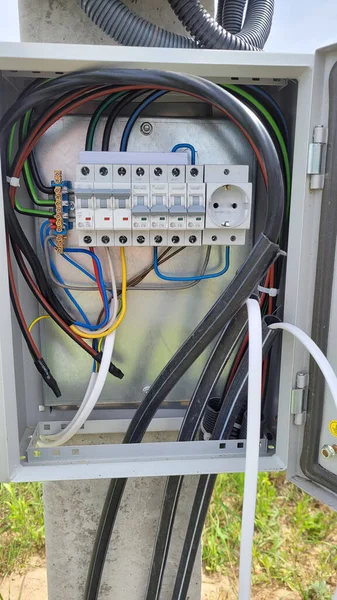 electricity distribution box with wires and circuit breakers (fuse box)