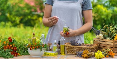 Woman with medicinal herbs and tinctures. Selective focus. Nature.