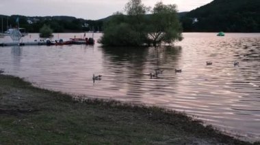 sunset at the Lake of the Edertalsperre, a hydroelectric dam in Germany, providing sustainable green energy.