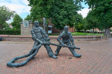 Delfzijl, Netherlands - 07 16 2022: Bronze statue in the city center of dutch Delfzijl