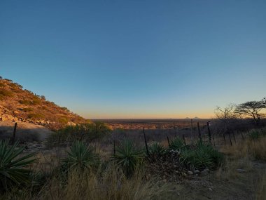 clear blue sky over the arid landscape of Namibia at sunset