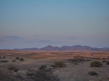 sunset over the arid landscape of the Kaokoveld near the skeleton coast in Namibia Africa