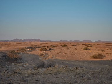 sunset over the arid landscape of the Kaokoveld near the skeleton coast in Namibia Africa