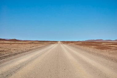 Kuzey Namibya 'da ıssız Damaraland' da çakıl yolu hiçliğe çıkıyor.