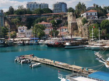 At the port of Antalya with many boats and houses