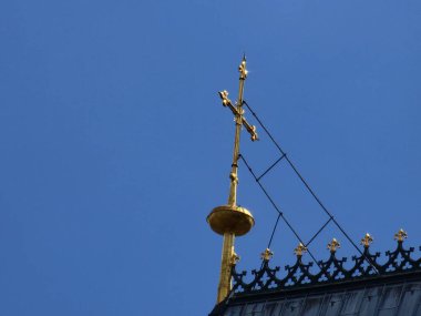 Golden cross on the main portal of a cathedral