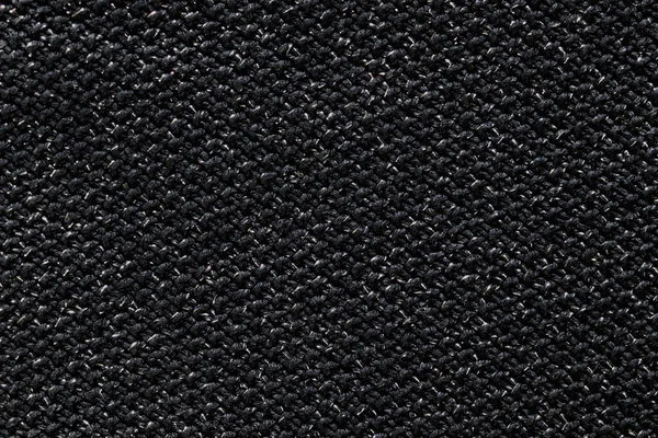 Kaba kumaşlı siyah bir arkaplan. Koyu, kaba arkaplan