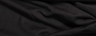 Dalgalı kumaş dokusundan bir afiş. Siyah arkaplan.