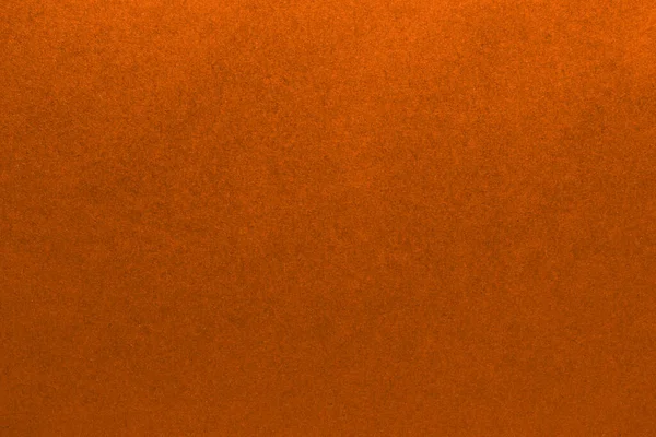 Orange brown paper background texture. Bright background with a cardboard pattern.