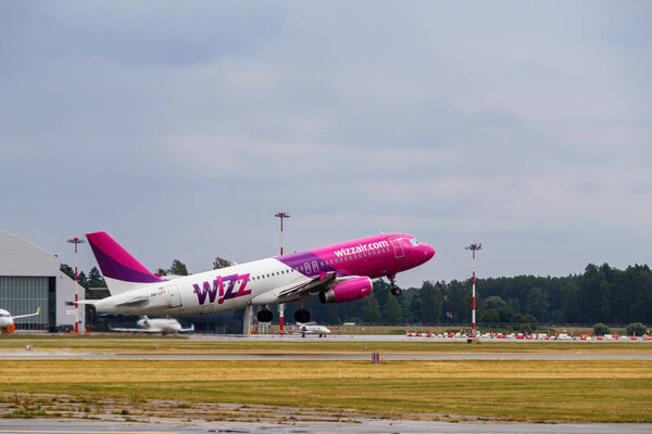 The plane takes off from the runway. Wizzair airline departs from Riga airport. Riga International Airport, Marupe, Latvia - 08 Jul 2022