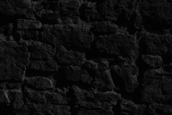 Dark background of black stones texture. Pattern of black stones.