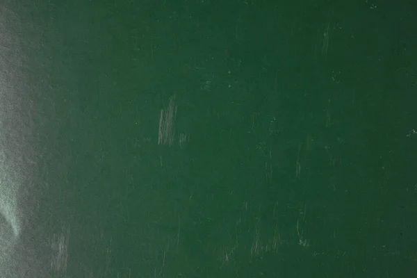 Background from old scratched green paper. Scratched paper texture background.