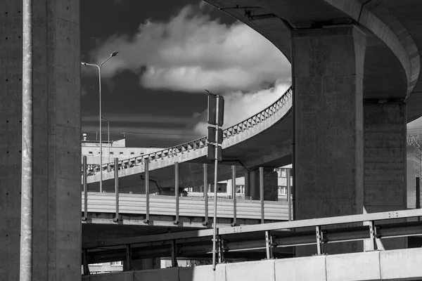 Abstract black and white photo with road, bridges and viaducts. Road infrastructure built from concrete.