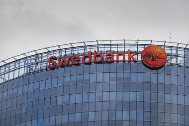 Swedbank central office building in Latvia. Swedbank inscription on the wall of the glass house. Riga, Latvia - 22 Aug 2022.