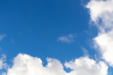 Background of blue sky and clouds. Space for text on blue sky background.