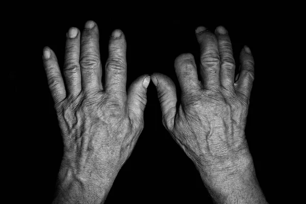 Old Hands Holding Black White Hand Dark Background — Stockfoto