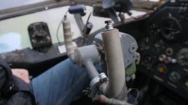 Close-up. Male hands of the pilot take the steering wheel of the plane. Vintage style. The old historical cabin AN-2.