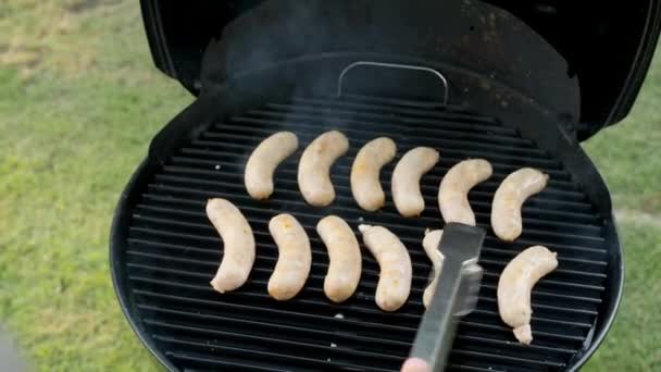 Mans Right Hand Flips Chicken White Gray Sausages Black Grill — Stockvideo