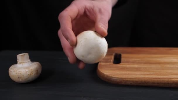 Mans Hand Dark Background Takes Mushroom Rolls Brown Wooden Cutting — Wideo stockowe
