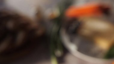 Panorama of a plate with pate decorated with carrots, mushrooms, garlic, slices of bread, olives, tomatoes. Presentation of the dish.