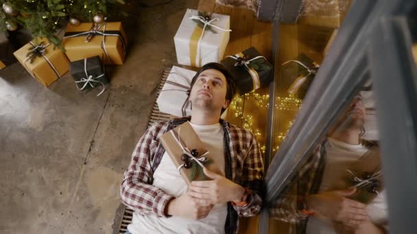 Depressed man on Christmas. Pessimistic guy feels trapped in house decorated New Years decor. Emotional breakdown. Alone on New years eve. Young sad male feeling lonely on Christmas Eve at home — Stock Video