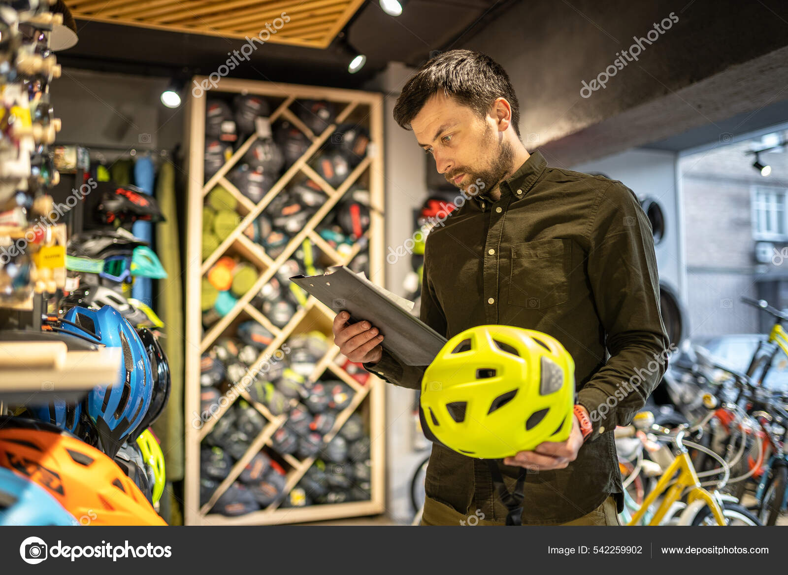 Male Bike Shop Manager Makes Inventory Sports Helmets Bike Shop