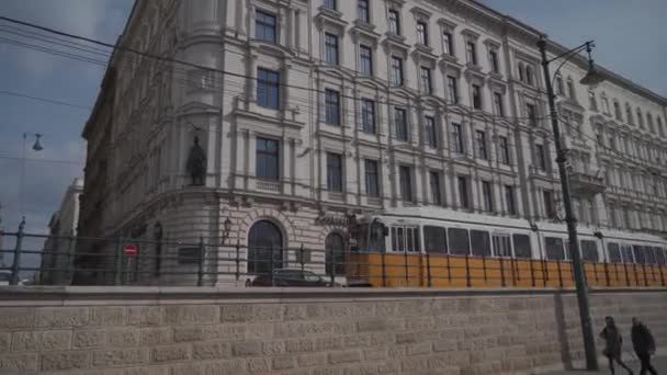 8 Mart 2022 Budapeşte, Macaristan. Budapeşte 'de toplu taşıma. Tipik sarı tramvay Budapeşte 'nin eski şehrinde raylardan geçiyor. — Stok video