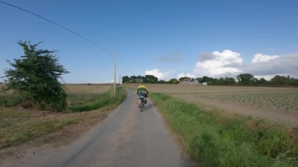 Normandiya 'nın kuzeyinde Mont Saint-Michel' e doğru, okyanusun yanındaki çakıl bisiklet yolunda iki bisikletlinin POV görüntüsü — Stok video