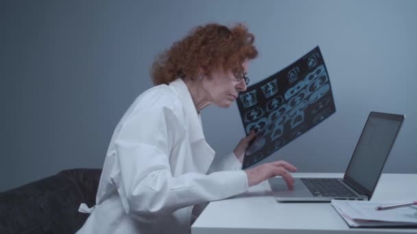 Senior Woman Doctor Doing Patients Chest Scan Laptop Office Mature — Vídeo de Stock