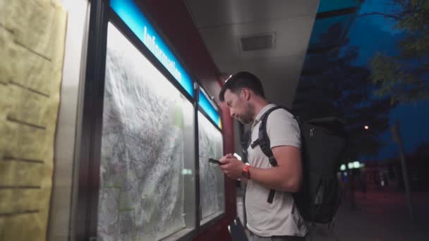 Thoughtful Traveler Using Tourist Transport Map Looking Best Way Transport — Stock video