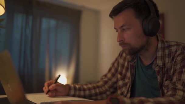 Male American Student Studies Online Home Studio Apartment Sitting Desk — Stockvideo