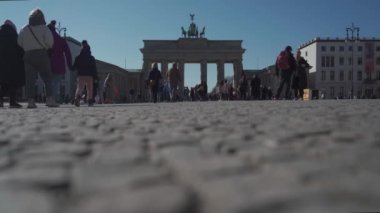 10 Mart 2022. Almanya. Berlin. Brandenburger Tor. Turistler güneşli bir bahar gününde Brandenburg Kapısı 'nda Berlins' in ana turistik yerlerinde dolaşırlar. Berlin 'de Neoklasik Zafer Kemeri. 