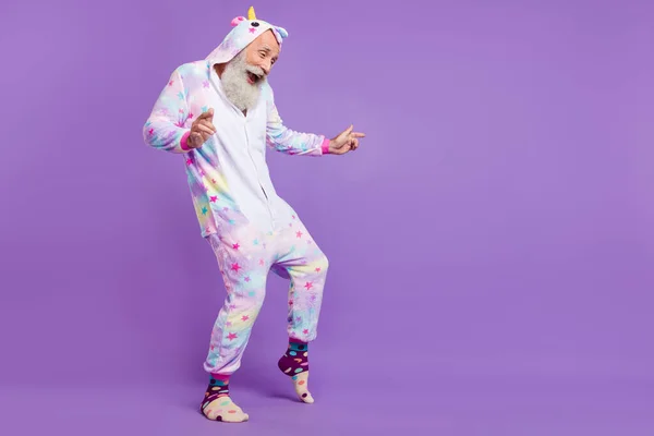 Full length photo of happy positive old man wear pajama dance good mood isolated on purple color background