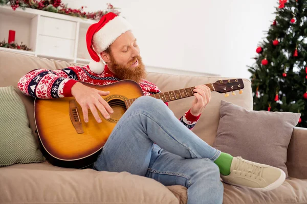 Photo of good mood handsome male playing guitar musician sing song sit sofa couch celebrate winter holiday at home — Stock Photo, Image