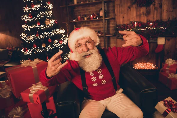 Portrait of attractive retired cheerful cool Santa showing horn having fun eve day advent at home loft industrial interior indoors — Stock Photo, Image