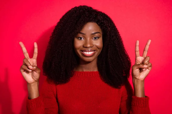 Φωτογραφία της νεαρής αφρικανικής κορίτσι ευτυχής θετικό χαμόγελο δείχνουν την ειρήνη δροσερό v-σημάδι απομονώνονται πάνω από το κόκκινο χρώμα φόντο — Φωτογραφία Αρχείου