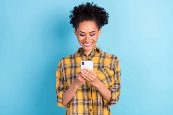 Foto portrét kudrnaté žena usmívá pomocí mobilního telefonu izolované pastelově modré barvy pozadí — Stock fotografie