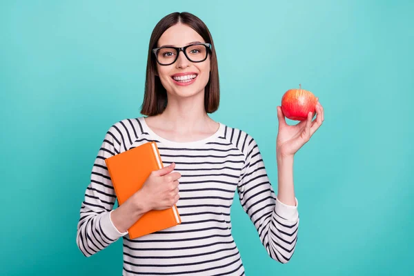 Foto de lady hold apple book break time wear eyeglasses striped shirt isolated on turquoise color background —  Fotos de Stock