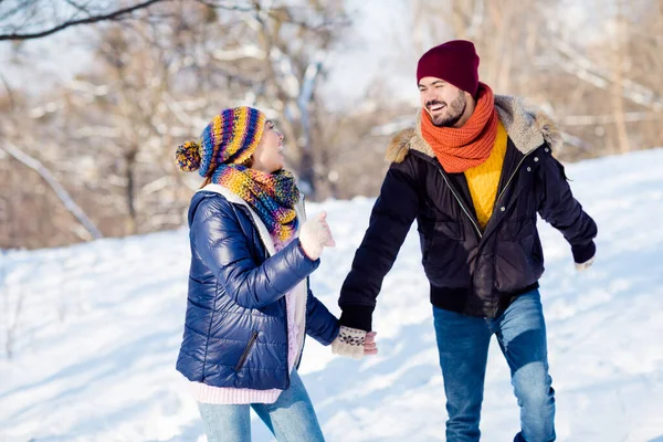 Φωτογραφία του χαρούμενου νεαρού ζευγαριού χαρούμενο θετικό χαμόγελο πάει βόλτα τρέχει πάρκο κρατήστε τα χέρια μαζί χειμερινές διακοπές χιόνι — Φωτογραφία Αρχείου