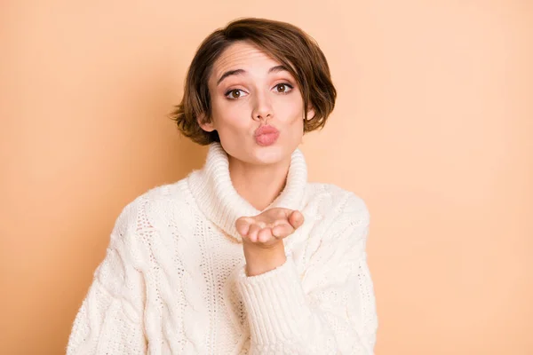 Foto de flerte bonito senhora enviar beijo de ar que você usa vestido de malha branco isolado no fundo cor bege pastel — Fotografia de Stock