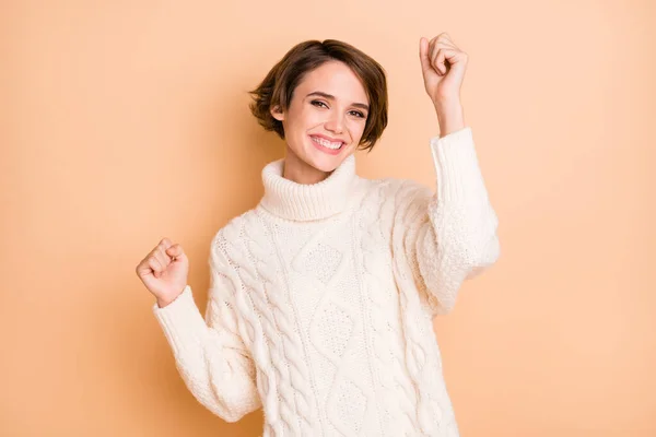 Photo portrait of beautiful girl cheerful gesturing like winner smiling isolated on pastel beige color background — Stock Photo, Image