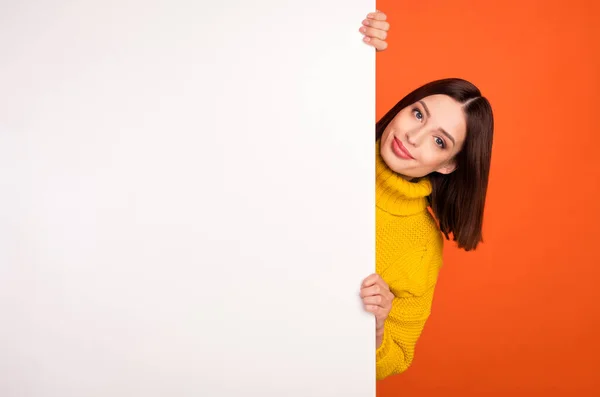 Photo of young woman happy positive smile hold hands poster advert information sale isolated over orange color background — Stock Photo, Image