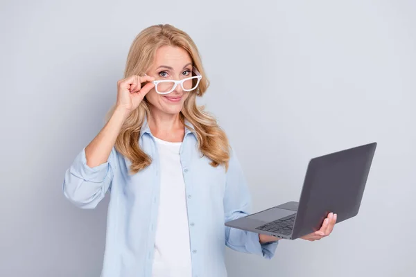 Photo of good mood young businesswoman in spectacles working in laptop agent expert isolated on grey color background — Stock Photo, Image