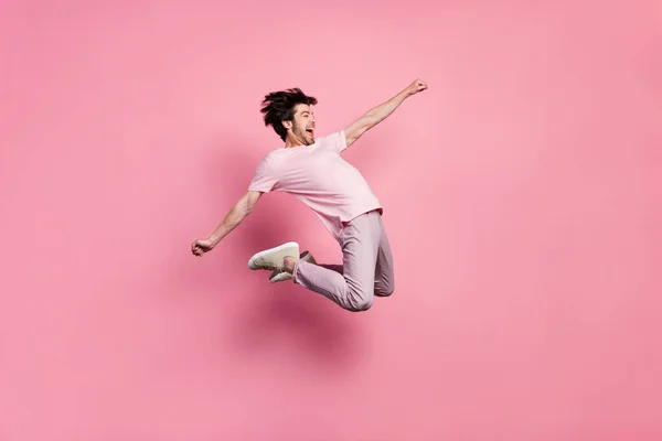 Full length body size man jumping up crazy overjoyed isolated pastel pink color background — Stock Photo, Image