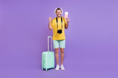 Full length body size photo man in hat keeping bags tickets won trip isolated pastel violet color background clipart